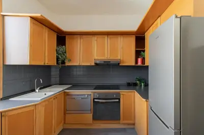 a kitchen with wooden cabinets and a refrigerator at iFlat Veneto Area's Penthouse in Rome
