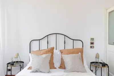 a bedroom with a white bed with pillows at iFlat Veneto Area's Penthouse in Rome