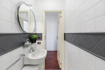 a bathroom with a sink and a mirror at iFlat Veneto Area's Penthouse in Rome