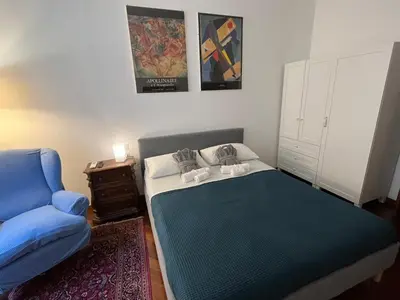 a bedroom with a bed and a flat screen tv at Torlonia Rooms in Rome