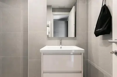 a bathroom with a white sink and a mirror at Numa Rome Verso in Rome