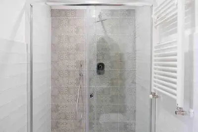a shower with a glass door in a bathroom at COLOSSEUM LUXURY HOME in Rome