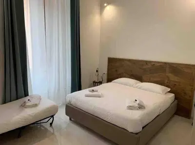 a bedroom with two beds with towels on them at COLOSSEUM LUXURY HOME in Rome