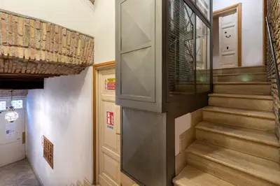 a staircase in a home with a glass entry door at Largo Arenula Suites in Rome