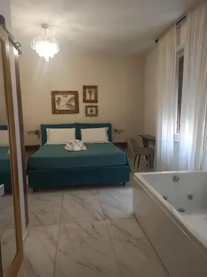 a bedroom with a bed and a bath tub at B&B Suite and Rooms San Giovanni in Rome