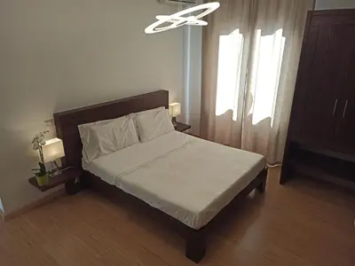 a bedroom with a bed and a ceiling fan at B&B Suite and Rooms San Giovanni in Rome