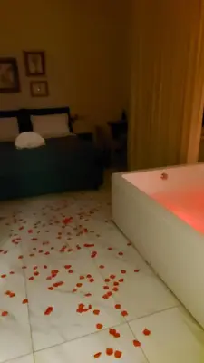 a bedroom with a bed with petals on the floor at B&B Suite and Rooms San Giovanni in Rome