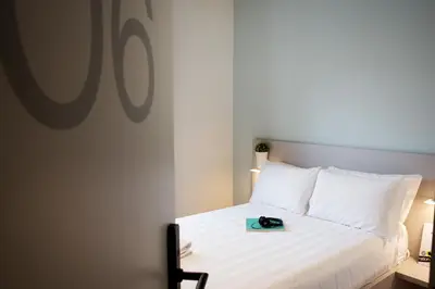 a bedroom with a bed with a book on it at Dotcampus Roma City Center in Rome
