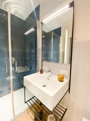 a bathroom with a white sink and a mirror at Dotcampus Roma City Center in Rome