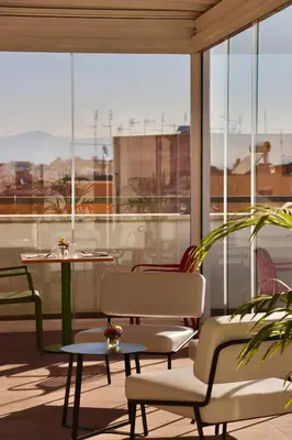a room with two tables and chairs and windows at Dotcampus Roma City Center in Rome