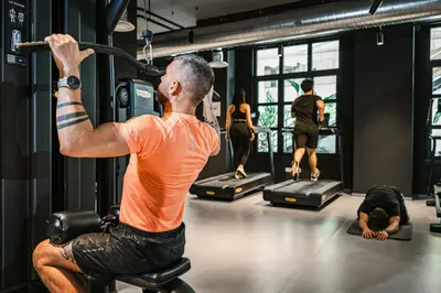 a man in a gym with a barbell at Dotcampus Roma City Center in Rome
