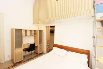 a bedroom with a bed and a desk at Angelo Emo Flat in Rome