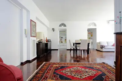 a living room with a table and a rug at Vatican Charme in Rome