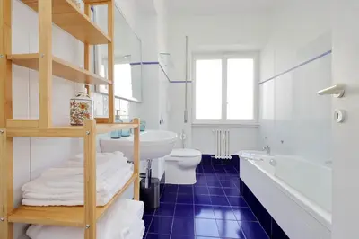 a bathroom with a white sink and a toilet and a tub at Vatican Charme in Rome