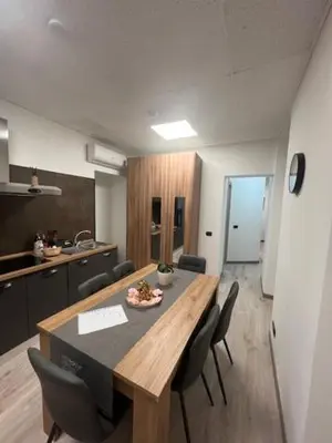 a room with a table and chairs in a kitchen at Lungotevere Testaccio 6 Roma - Apartments in Rome