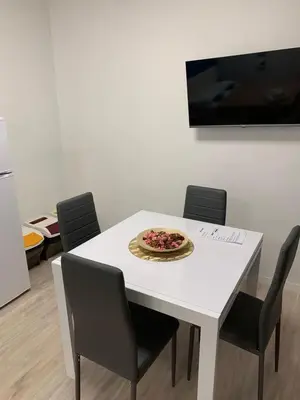 a white dining room table with a plate of food on it at Lungotevere Testaccio 6 Roma - Apartments in Rome