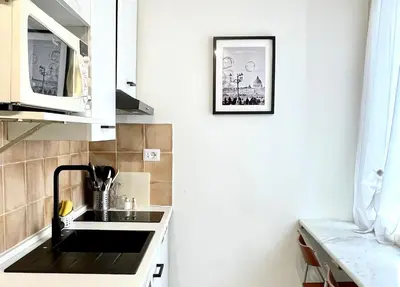 a kitchen with a sink and a picture on the wall at Apt in front of the Vatican City in Rome
