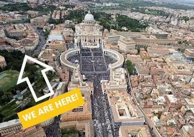 an aerial view of a city with a building at Apt in front of the Vatican City in Rome
