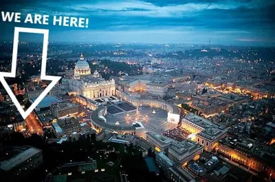 a view of a city at night with the words we are here at Apt in front of the Vatican City in Rome