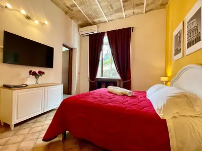 a bedroom with a bed with a red blanket at Apt in front of the Vatican City in Rome