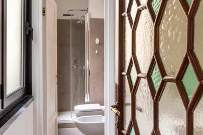 a bathroom with a toilet and a shower at DEZA Case vacanza Nazionale Joy e Living in Rome