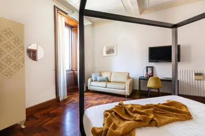 a bedroom with a bed and a living room at DEZA Case vacanza Nazionale Joy e Living in Rome