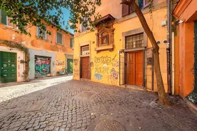an alley with graffiti on the side of a building at Old Trastevere Studio in Rome