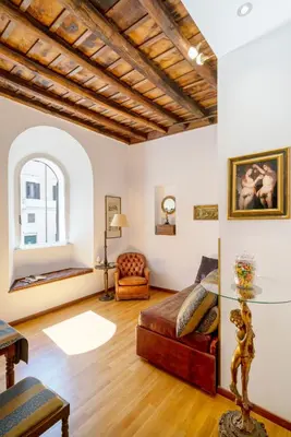 a living room with a couch and a glass table at Pantheon Caravaggio's House in Rome