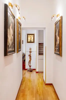 a hallway with paintings on the walls of a room at Pantheon Caravaggio's House in Rome