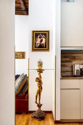 a living room with a statue in the middle of a room at Pantheon Caravaggio's House in Rome