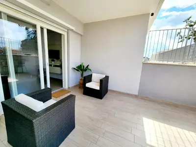 a living room with chairs and a large window at Quela Apartment - Pietralata in Rome