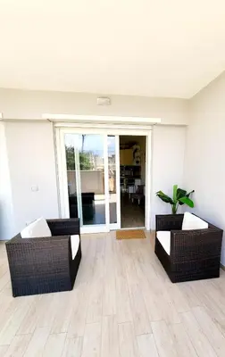 a living room with two couches and a plant at Quela Apartment - Pietralata in Rome