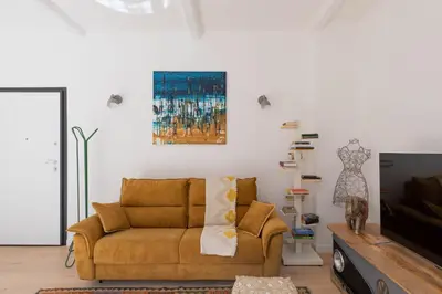 a living room with a couch and a tv at iFlat Shiny Loft in Trastevere in Rome