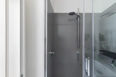 a shower with a glass door in a bathroom at iFlat Shiny Loft in Trastevere in Rome