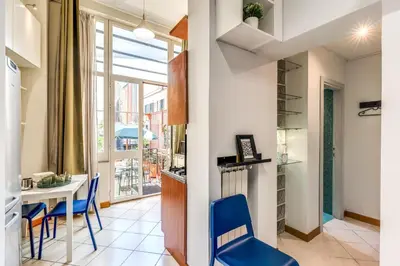 a kitchen and dining room with a table and chairs at Residenza Como in Rome
