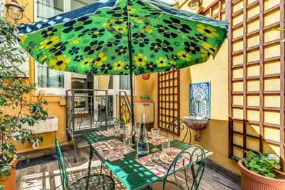a table with an umbrella on a patio at Residenza Como in Rome