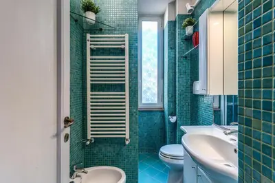 a bathroom with a toilet and a sink at Residenza Como in Rome