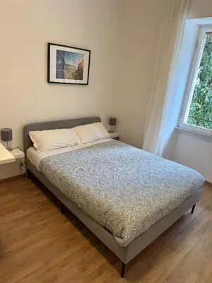 a bed in a bedroom with a window at Rhome Holiday Fornaci in Rome