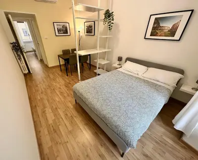 a bedroom with a bed and a desk in it at Rhome Holiday Fornaci in Rome