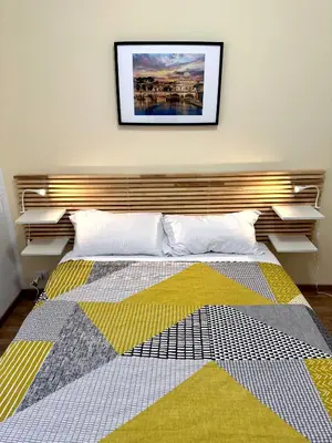a bedroom with a bed with a picture on the wall at Rhome Holiday Fornaci in Rome