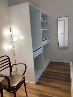 a dining room with a chair and a mirror at Casa MANÍ Campo de Fiori in Rome