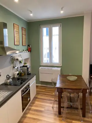 a kitchen with a table and a dining room at Casa MANÍ Campo de Fiori in Rome