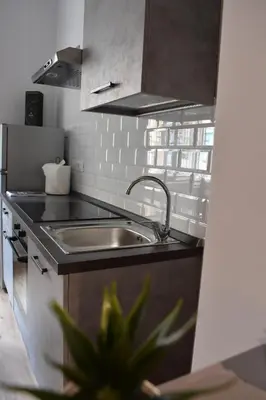 a kitchen with a sink and a counter top at Gallery House 59 Guest House in Rome