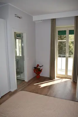 a room with white walls and a large window at Gallery House 59 Guest House in Rome