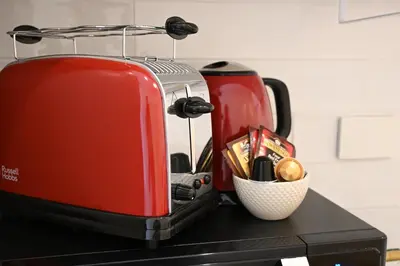 a red toaster sitting on top of a counter at Colosseum Boutique Apartment in Rome