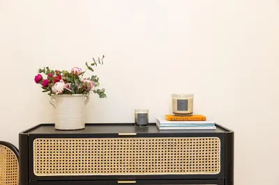 a table with a vase of flowers on top of it at Colosseum Boutique Apartment in Rome