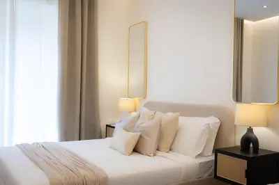 a bedroom with a white bed with white pillows at Colosseum Boutique Apartment in Rome