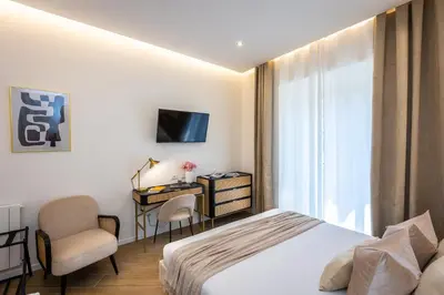 a hotel room with a bed and a desk and a television at Colosseum Boutique Apartment in Rome