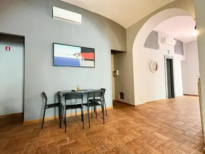 a dining room with a table and chairs at Tolemaide Boutique Apartment in Rome