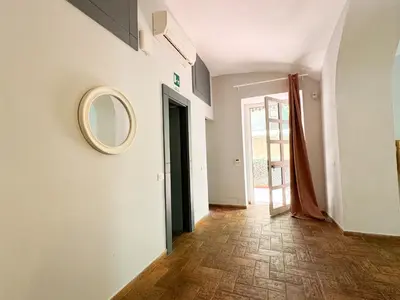 a hallway with a mirror on a wall and a door at Tolemaide Boutique Apartment in Rome